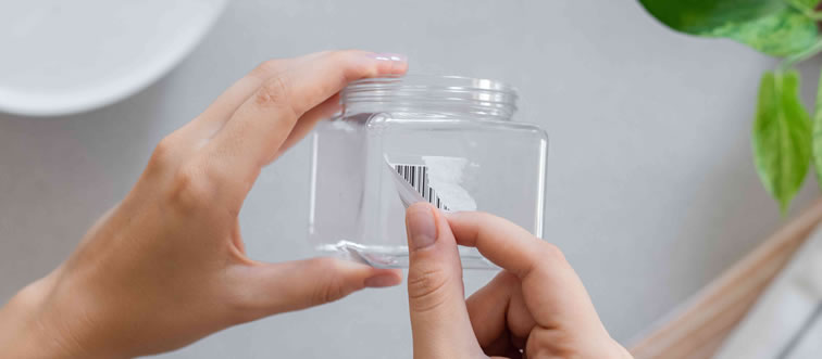 What is the simplest method for getting a persistent sticker off of glass?